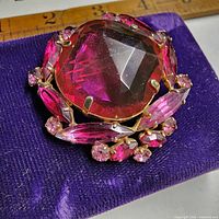 Front view showing central stone and surrounding rhinestones