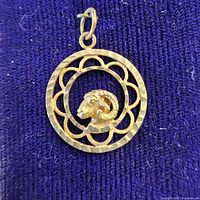 Front of pendant showing ram head and openwork frame