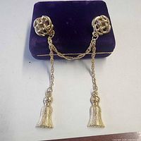 Front view of gold-tone scarf clip on purple display block