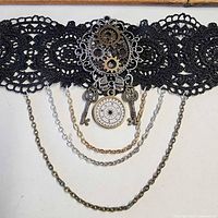 Full view of steampunk lace choker showing gears, keys, compass charm and layered chains