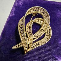 Front view of Birks sterling silver ribbon brooch