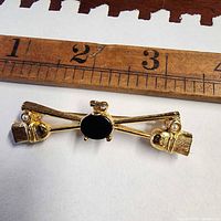 Brooch beside ruler showing length