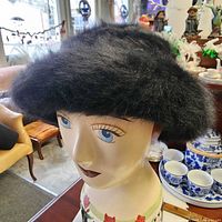 Front view of black fur hat on mannequin head
