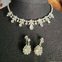 necklace on bust with earrings below