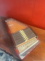 Full view of autoharp showing body, chord bars, keys and strings