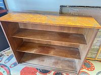 Front view showing entire bookcase and marbled top surface