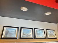 Four framed prints on shelf