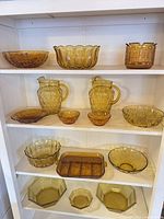 Full shelving view showing all amber glass pieces