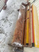 Full top view of wooden church pew showing seat and back shelf