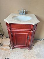 Full view of vanity cabinet with sink and faucet