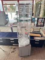 Full view of Cardinal branded clear acrylic display on gray base