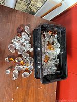 Top view showing loose clear and amber prisms beside tub