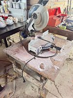 Delta ShopMaster miter saw on wooden stand, side view