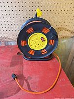 Front view of extension cord reel showing four outlets and power switch