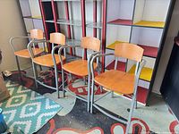 Four matching barstools arranged side by side showing overall design and materials
