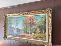 Front view of framed oil painting on wall