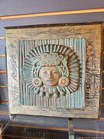 Front view of framed Indigenous head relief plaque