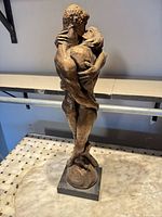 Full view of J. Cox embracing couple sculpture on base