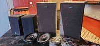 Two floor speakers, two bookshelf speakers, two loose Kenwood car speakers, two bagged items
