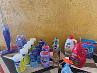 Full lot view on floor showing mop, wipes, cleaners, detergents