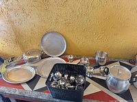 Overview of stainless cookware, bowls, platters, pressure cooker