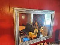 Front view of rectangular mirror hung on wall