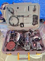 Open case showing grinder, attachments, flexible shaft and disc sander