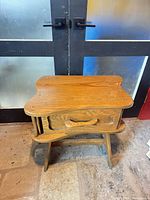 Front view of wooden night stand showing top, drawer, legs