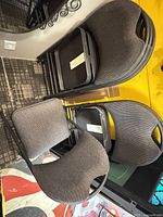 Stacked view of six folding chairs showing padded seats, backrests, metal frames