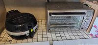 Air fryer and toaster oven side by side on tiled countertop