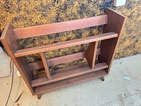 Full front view of the teak shoe rack showing overall structure