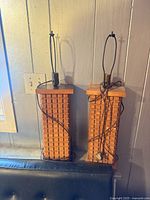 Front view of both wooden cube-pattern lamps with cords visible