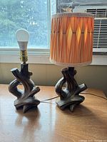 Both lamps side by side on table, one with shade, one without