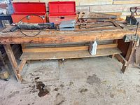 Full view of wood workbench with shelf and vises