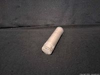 Single photo of the coin roll on black backdrop