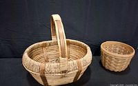 Oval wicker basket and round splint basket side by side displaying size, weave and condition