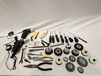 All tools laid out showing variety of hand and power tools, brush wheels, pliers, wrenches