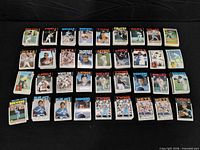 Front view showing all stacks of 1986 Topps baseball cards arranged on black background