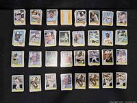 Overview of multiple small stacks of 1981 Topps baseball cards laid out in rows
