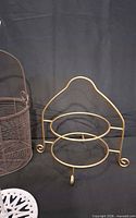 Brown metal basket and gold-tone two-tier stand