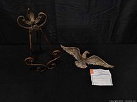 Brass eagle ornament and metal easel together
