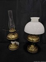 Front view showing both brass tone hurricane lamps