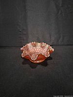 Angled view showing overall bowl shape and iridescent marigold colour