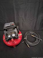 Air compressor and hose shown together, identifying brand, style, included accessory