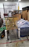 Stack of three wire crab traps showing black, yellow, and black cages with PVC floats