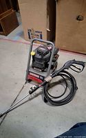 Front view of Craftsman pressure washer with coiled hose and spray wand