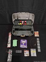 Open tackle box showing contents laid out