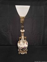 Full view of hand-painted floral porcelain lamp with brass base and frosted glass shade
