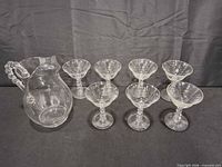 pitcher and seven matching cups grouped