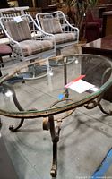 Angled view showing full table, glass top and metal base